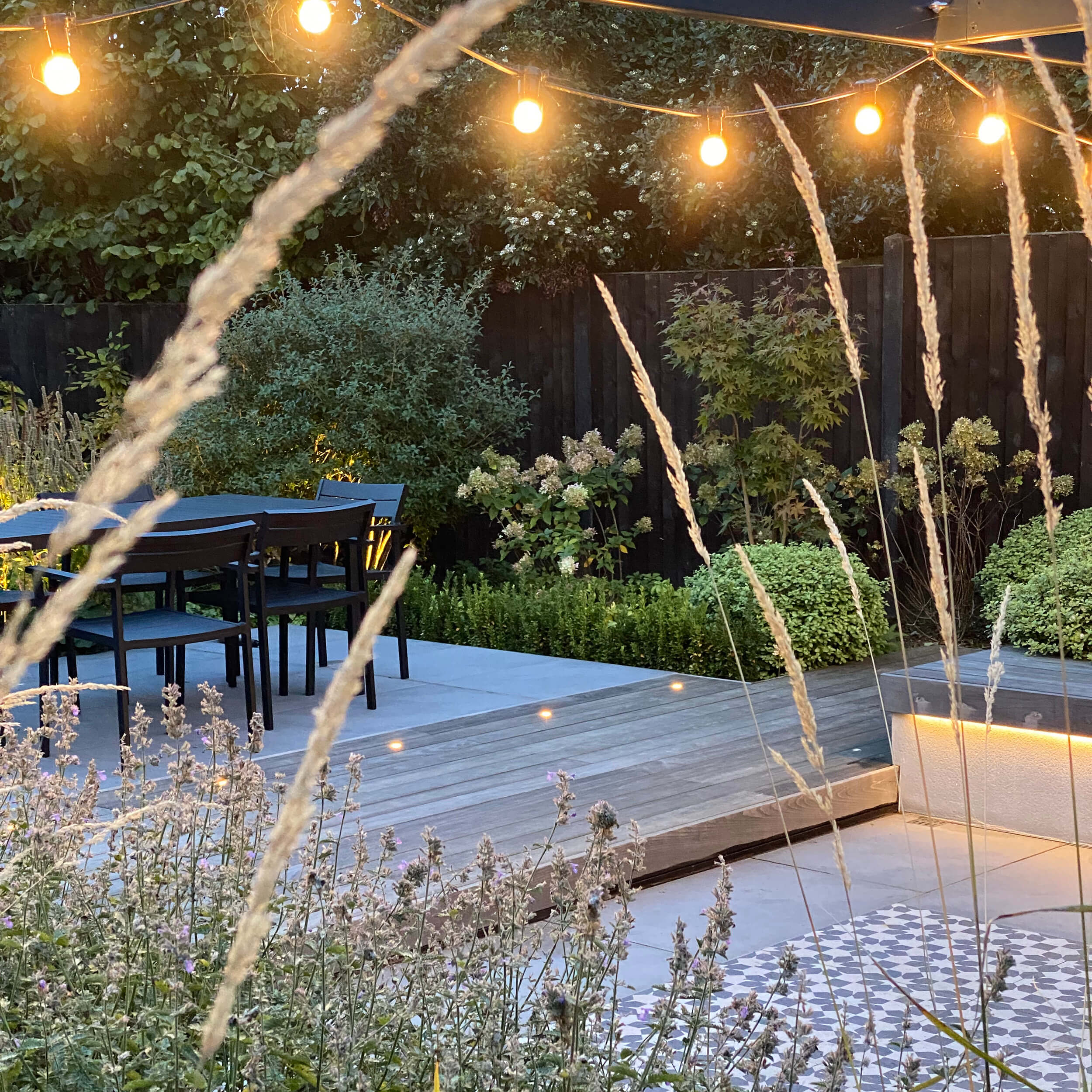 Multiple zones for socialising and dining are separated by a decking path