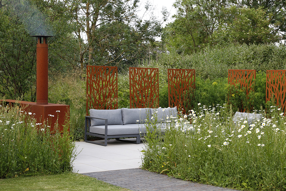 Lazer-cut Corten steel panels create a sense of privacy while maintaining the views from the comfy seating